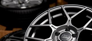Wheel in focus with Tire/Wheel combo's in distance