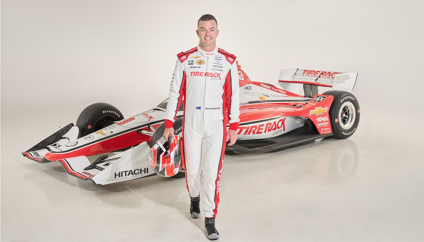 Scott McLaughlin of Team Penske Standing and Holding Racing Helmet Posed in front of TR3 Car
