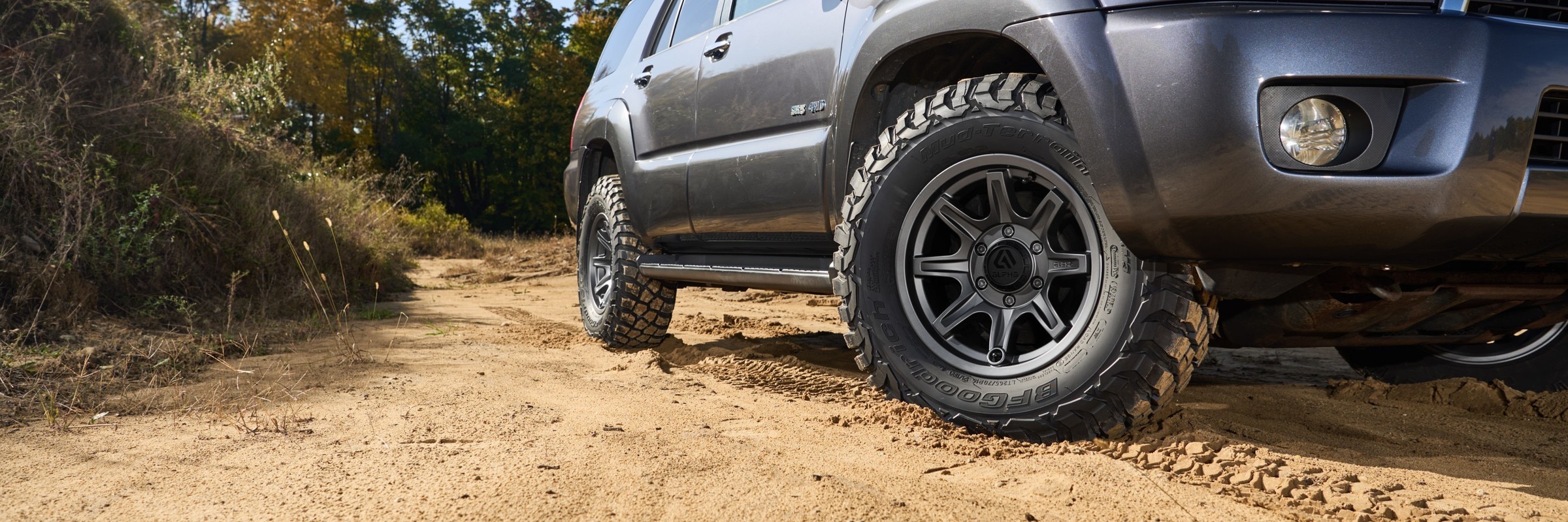 Toyota 4Runner with BFGoodrich tires driving on a dirt trail.