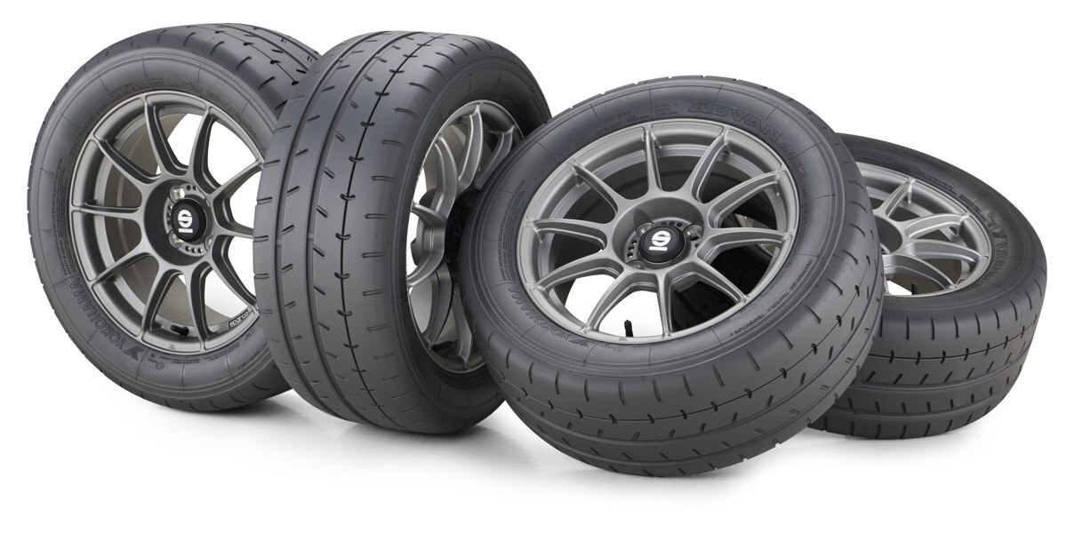 Four Yokohama SPARCO tires laid out horizontally, showing tires and wheels.