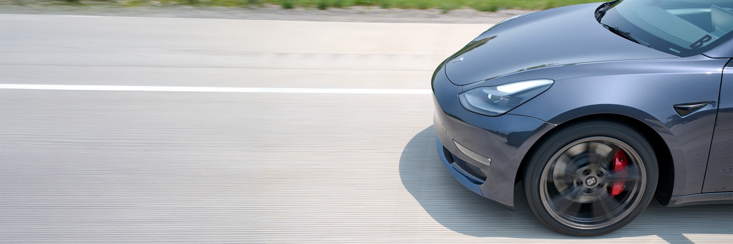 2023 Tesla Model 3 in Motion on Road with Fuel-Efficient Tires