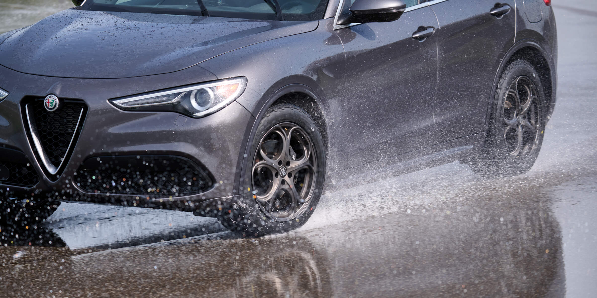 Testing crossover tires on the wet track using a 2023 Alfa Romeo Stelvio for the real-world ride and drive report.