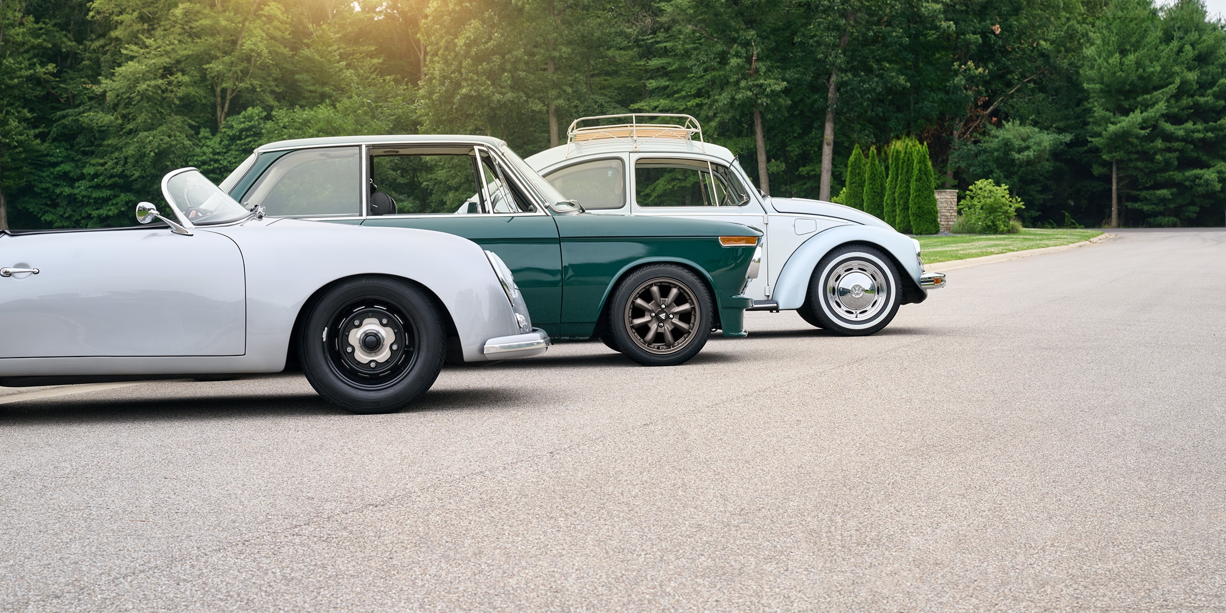 Classic cars parked side by side showing vintage styling and classic car tire details.