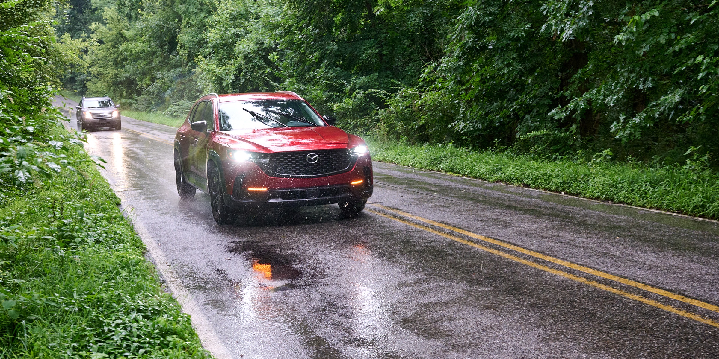 SUV driving on all-season tires in wet conditions