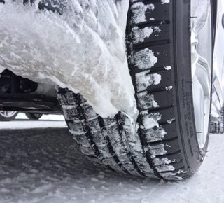 Close up of a snow packed Pilot Sport A/S 3+.