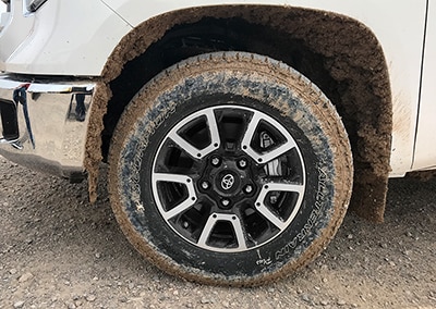 Straight on shot of a muddy Scorpion All Terrain Plus